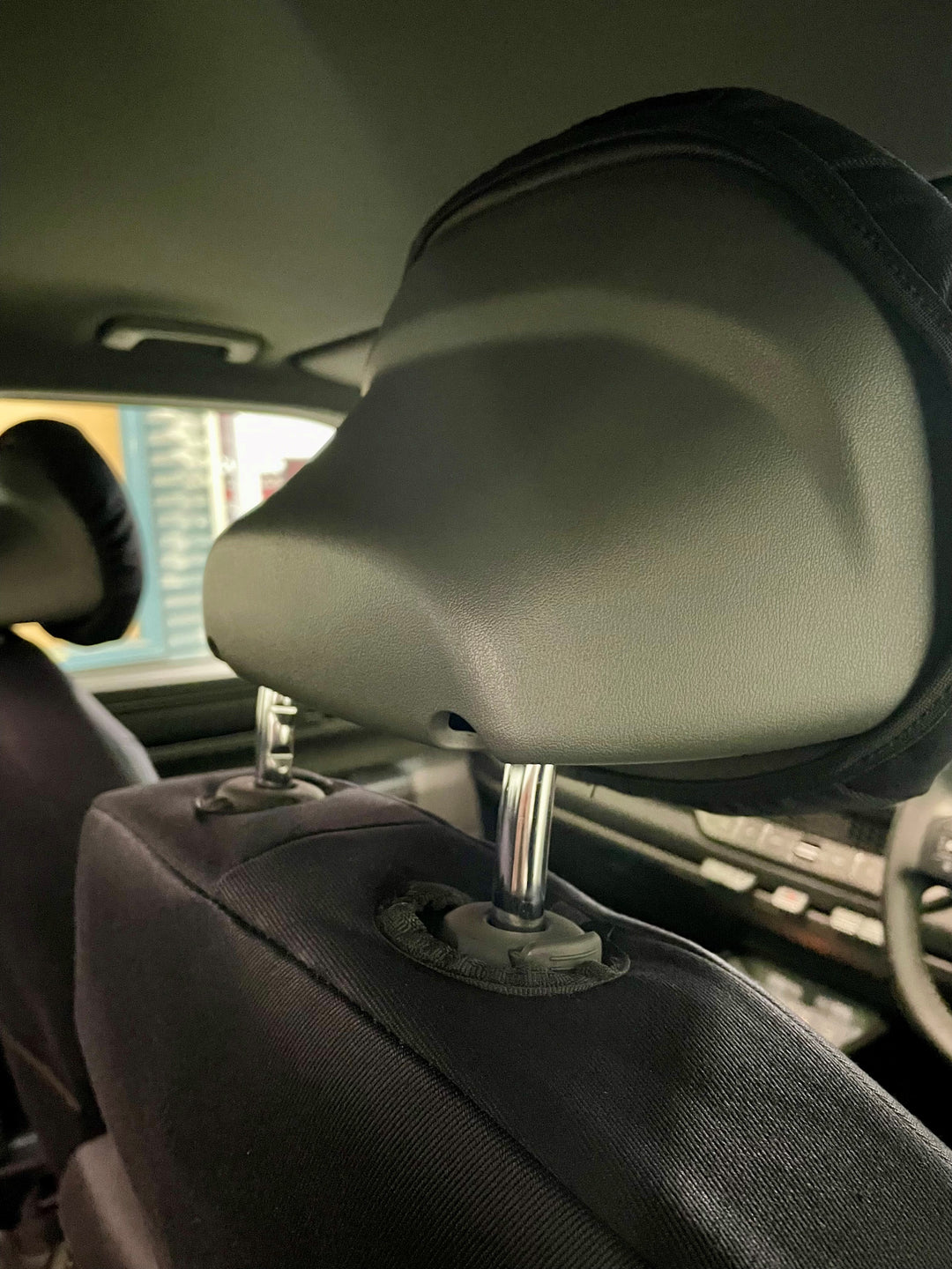 Car interior showing close up of head rest area.