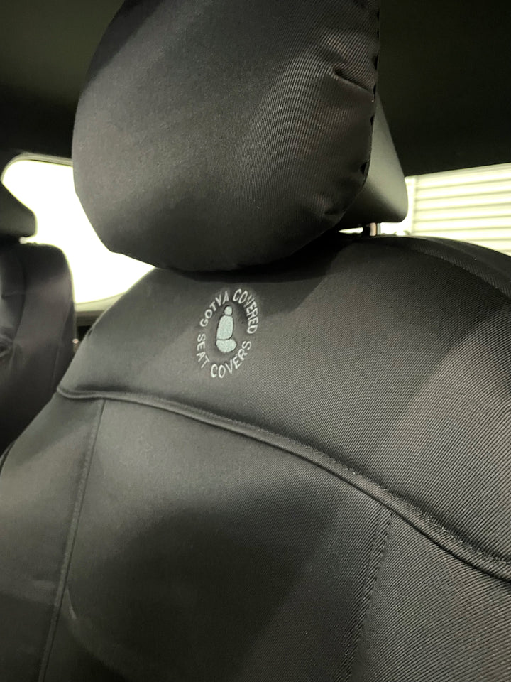close up of kia tasman passenger seat fitted with denim seat cover and GYC logo.