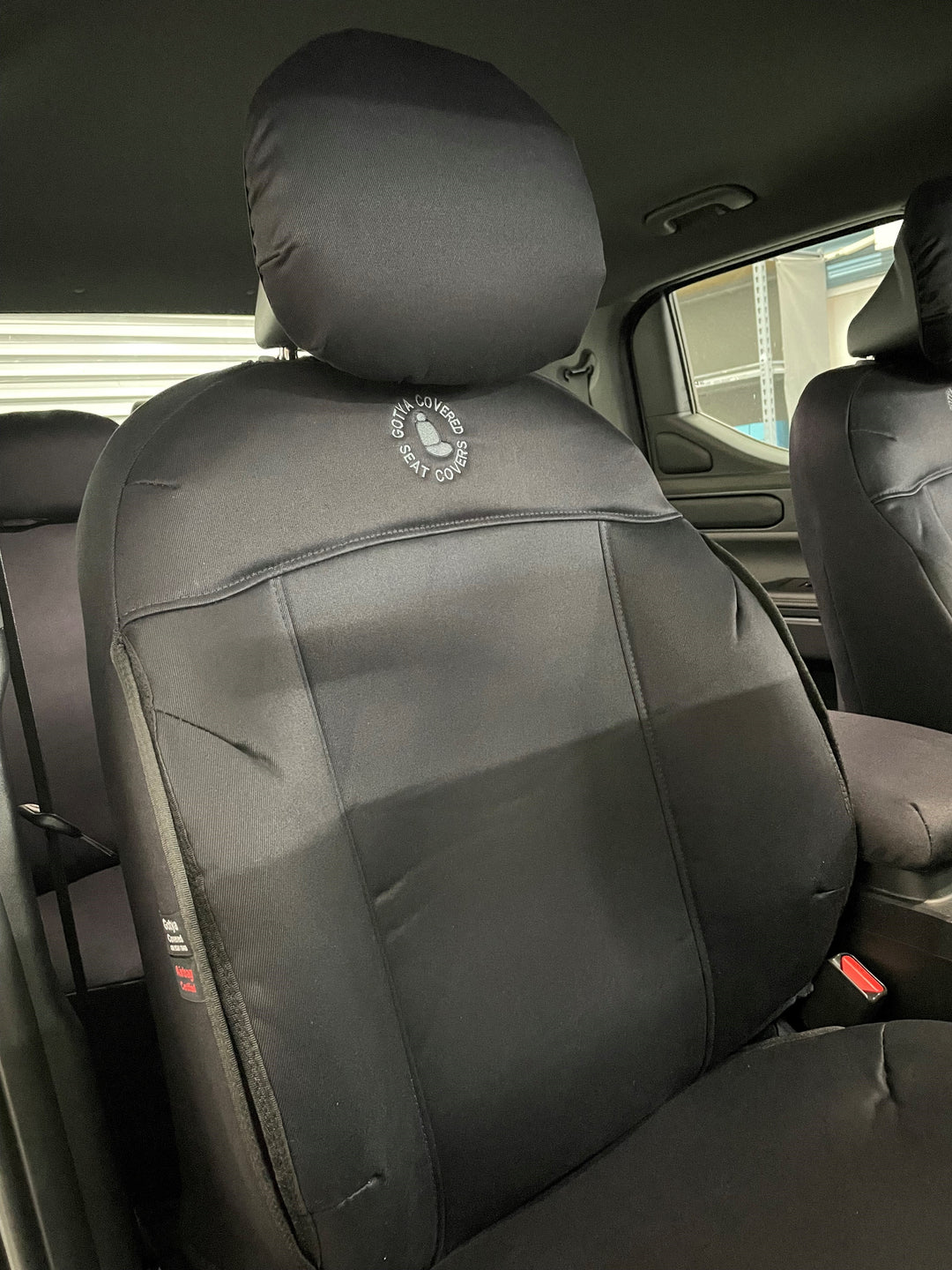 Close up of driver seat cover with GYC logo.